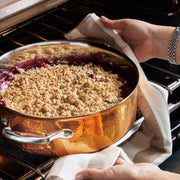 Close-up of a Ruffoni Symphonia Cupra 7QT braiser with stainless steel interior and clad copper lid, ideal for versatile stovetop-to-oven cooking.