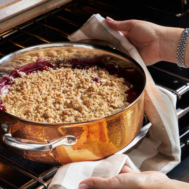 Close-up of a Ruffoni Symphonia Cupra 7QT braiser with stainless steel interior and clad copper lid, ideal for versatile stovetop-to-oven cooking.