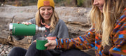 A person holding the Klean Kanteen 25oz Insulated Thermos with Built-In Cup and Pourer, ideal for versatile beverage needs during outdoor adventures.