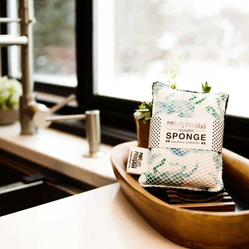 Marley's Monsters washable sponge in green surprise print, offering a sustainable, reusable cleaning option; compatible with machine and dishwasher washing for convenience.