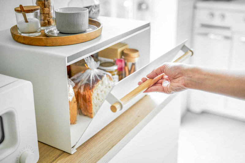 Yamazaki | Simple Steel Bread Box - Black on a kitchen counter, storing sliced bread and jars. A round tray holds sugar jars on top.