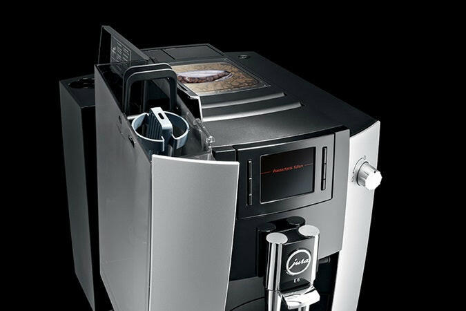 Jura | E6 - Fully Automatic Espresso + Coffee Machine, featuring AromaG3 grinder and P.E.P.® technology, displayed with intuitive TFT color display and interchangeable milk spout.