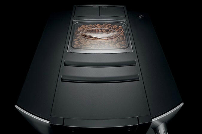 Jura E6 Fully Automatic Espresso + Coffee Machine with TFT display and interchangeable milk spout, featuring AromaG3 grinder and Pulse Extraction Process for premium coffee quality.