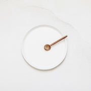 Looks Like White | Scandi Cereal Bowl on a white surface, featuring a small wooden spoon, exemplifying minimal elegance and handcrafted design by Trudy Crane.