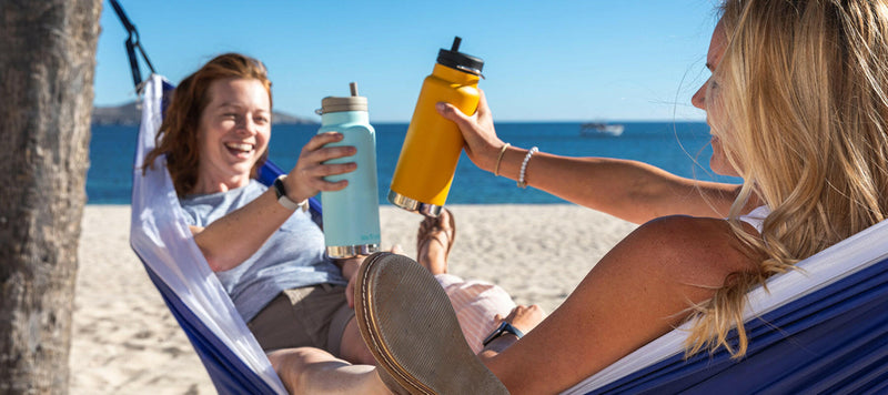 Klean Kanteen | 32oz TKWide Insulated Water Bottle with Twist Cap - Tiger Lily, held outdoors, ideal for sports and hydration, featuring a leak-proof design with a reusable straw.